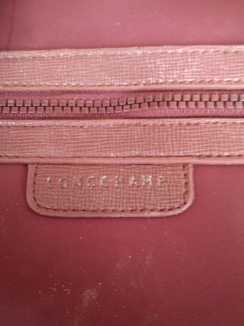 Longchamp Burgundy Crossbody Bag (Category: Cross-body Bags) located in Manila. Submitted by mysticshark-0a05e9 (Listing ID 1469756150, Image 2). Description: - Authentic Longchamp crossbody bag, proudly made in France - Elegant burgundy color with stylish textured trim accents - Crafted from signature durable nylon fabric with a secure zipper closure and metallic puller - Features a convenient exterior zip pocket and an adjustable strap for comf