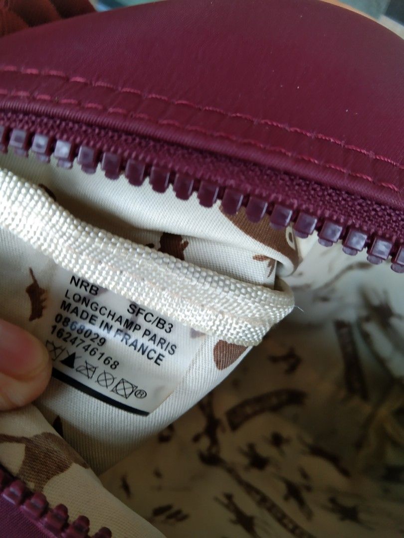 Longchamp Burgundy Crossbody Bag (Category: Cross-body Bags) located in Manila. Submitted by mysticshark-0a05e9 (Listing ID 1469756150, Image 3). Description: - Authentic Longchamp crossbody bag, proudly made in France - Elegant burgundy color with stylish textured trim accents - Crafted from signature durable nylon fabric with a secure zipper closure and metallic puller - Features a convenient exterior zip pocket and an adjustable strap for comf