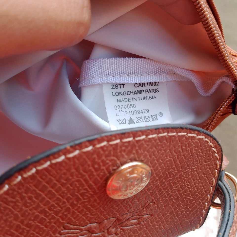 Longchamp Le Pliage Cuir Pouch Brown (Category: Luxury Bags & Wallets) located in Muntinlupa City. Submitted by armendaber03743 (Listing ID 1469636950, Image 2). Description: - Authentic Longchamp pouch in a stylish rich brown nylon - Features a structured top flap with a secure gold snap closure - Secure zippered main compartment for your essentials - Interior tag reads: Longchamp Paris, Made in Tunisia - Includes a brand new, detachable shoulde