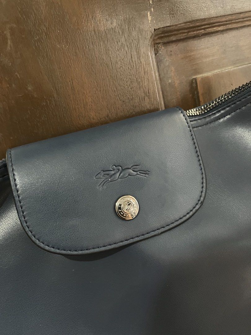 Longchamp Navy Leather Shoulder Bag (Category: Luxury Bags & Wallets) located in Mabalacat. Submitted by onlygrail.pamp (Listing ID 1469634277, Image 2). Description: - Brand: Longchamp - Color: Navy blue - Material: Premium leather - Closure: Secure top zip with branded metal pull - Front Detail: Embossed logo flap with snap button - Strap: Adjustable matching strap with silver-toned hardware rings - Condition: Sturdy construction, clean, and id