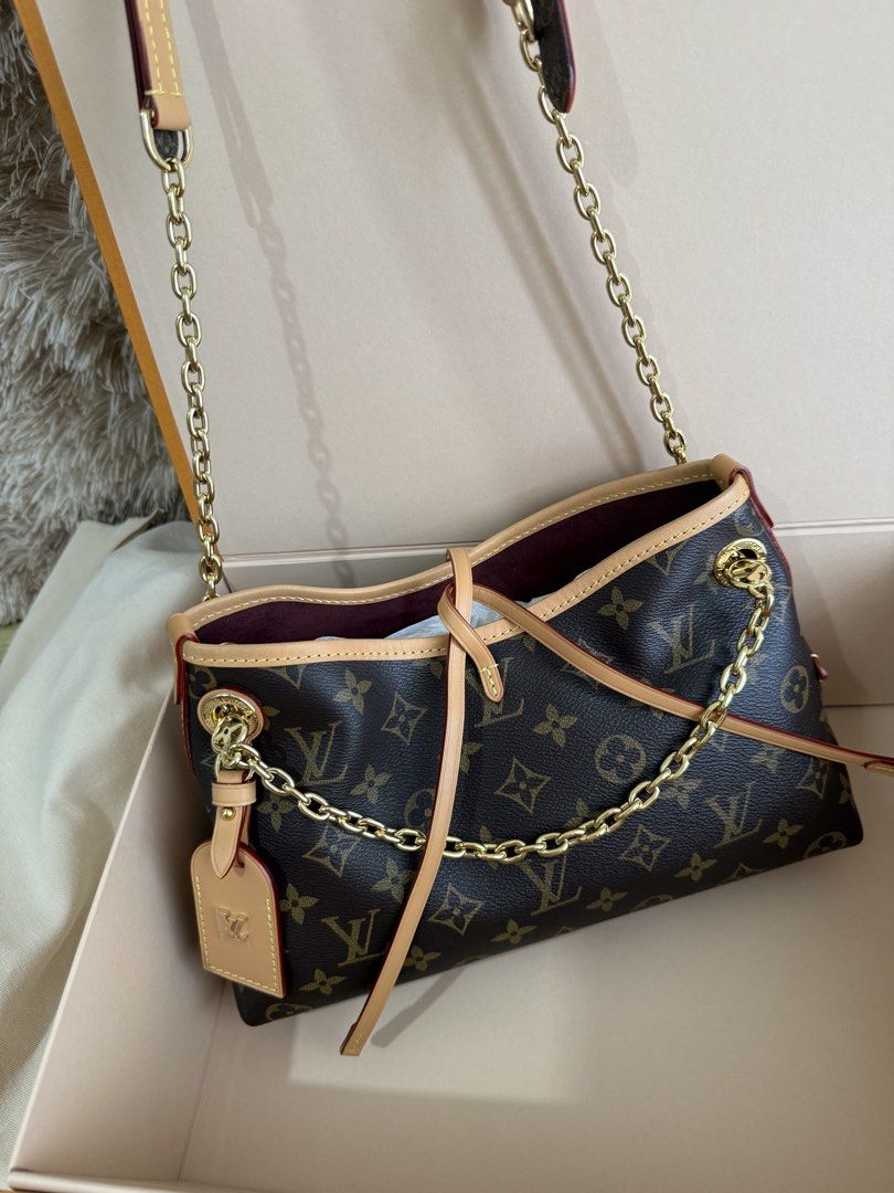Louis Vuitton Carryall BB Monogram Shoulder Bag (Category: Luxury Bags & Wallets) located in Manila. Submitted by lunacakes (Listing ID 1469623380, Image 2). Description: - Brand: Louis Vuitton - Pattern: Monogram Canvas (Dark Brown) - Straps: Includes gold-tone chain strap and adjustable leather strap - Details: Natural cowhide leather trim with red edging and removable LV-stamped name tag - Interior: Burgundy lining - Condition: Brand new with 