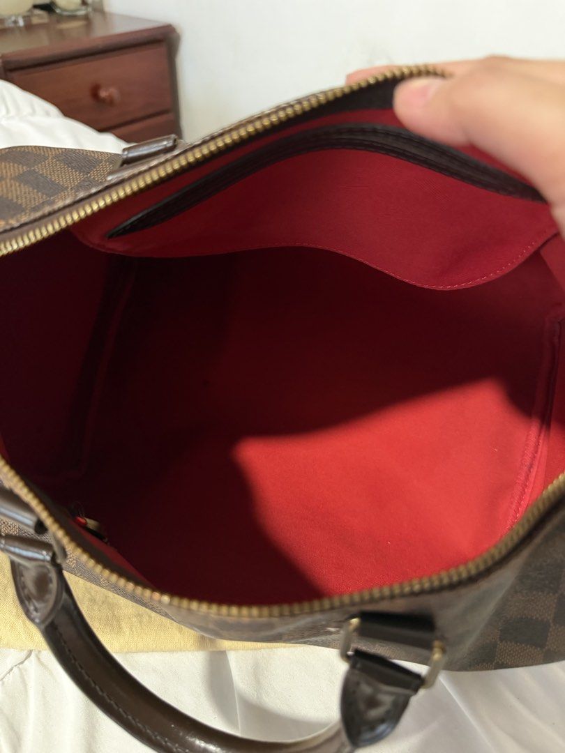 Louis Vuitton Damier Ebene Speedy 30 (Category: Luxury Bags & Wallets) located in Cavite. Submitted by gentlyused_ (Listing ID 1469683648, Image 2). Description: - 100% Authentic Louis Vuitton Damier Ebene Speedy bag - Iconic brown checkerboard canvas with dark brown leather handles and trim - Gleaming gold-tone hardware and secure top zipper closure - Spacious red fabric interior featuring a handy slip pocket - Includes original padlock on the s