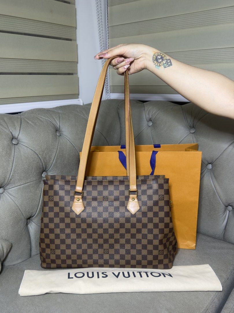 Louis Vuitton Damier Ebene Tote Bag (Category: Looking For) located in Caloocan City. Submitted by kimmndza_176 (Listing ID 1469662653, Image 1). Description: - Brand: Louis Vuitton - Material: Classic Damier Ebene canvas with tan leather straps - Hardware: Gold-tone - Condition: Great structure with a very clean interior - Inclusions: Original LV dust bag and orange shopping bag - Style: Timeless everyday carryall - Location: Ships from Philippi