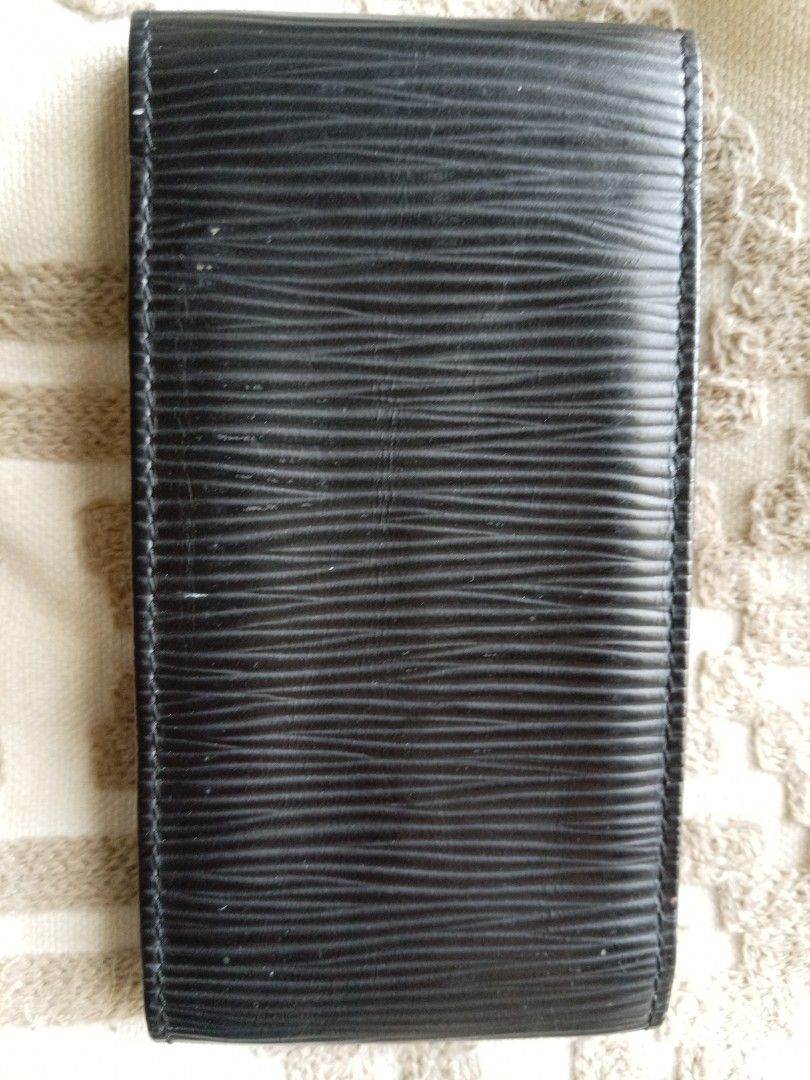 Louis Vuitton Epi Leather Cigarette Case Black (Category: Luxury Bags & Wallets) located in Las Pinas. Submitted by bettybellv (Listing ID 1469582406, Image 2). Description: - Authentic Louis Vuitton cigarette case crafted from signature black Epi leather - Features a textured finish with the iconic LV logo embossed on the front flap - Solid construction with durable, sturdy stitching along the sides - Interior stamped with Louis Vuitton Paris Ma