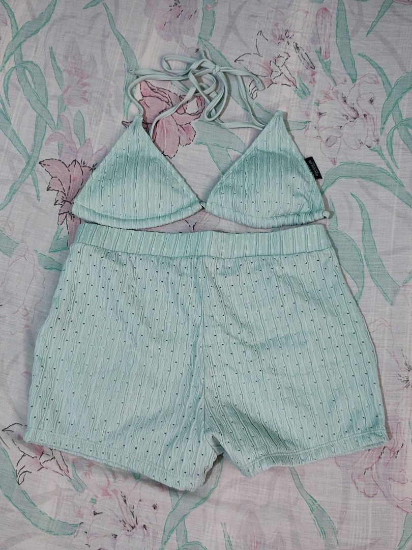 Lovito Mint Green Halter Bikini and Shorts Set (Category: Bikinis & Swimsuits) located in Noveleta. Submitted by preloved__items___ (Listing ID 1469617221, Image 2). Description: - Brand: Lovito - Condition: used once - Color: Mint green - Style: Two-piece swimwear set with a triangle halter top and matching high-waisted shorts - Material/Design: Textured fabric with charming small eyelet details - Comfort features: Adjustable halter neck ties an