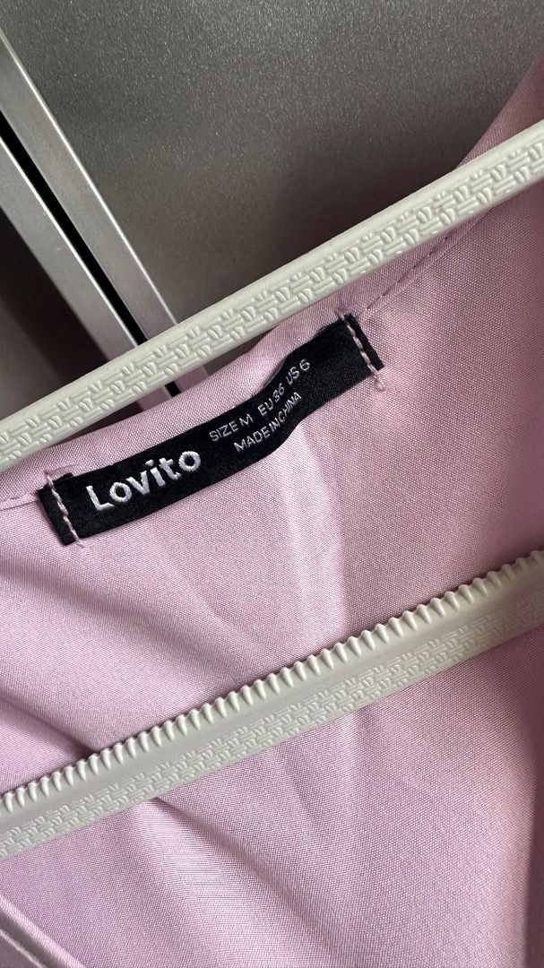 Lovito Purple Wrap Blouse Size M (Category: Blouses) located in Cavite. Submitted by bravesoul99 (Listing ID 1469730003, Image 3). Description: - Brand: Lovito - Color: Light Purple - Size: Medium (EU 36, US 6) - Design: Wrap style with V-neck, short puff sleeves, and side faux buttons - Back Detail: Adjustable tie-back - Hem: Trendy asymmetric hem - Material: Textured weave fabric - Origin: Made in China - Condition: Excellent, ready to wear.