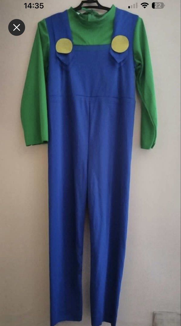 Luigi Costume Jumpsuit and Hat (Category: Babies & Kids Fashion) located in Quezon City. Submitted by ja.layug (Listing ID 1469627730, Image 1). Description: Green and blue Luigi costume set. Includes long-sleeve green top attached to blue overalls with yellow button details. Matching green cap with white circle and green letter L on the front. Neck ties at the back. Fun outfit for dress-up parties or cosplay events. One-piece design makes it qui
