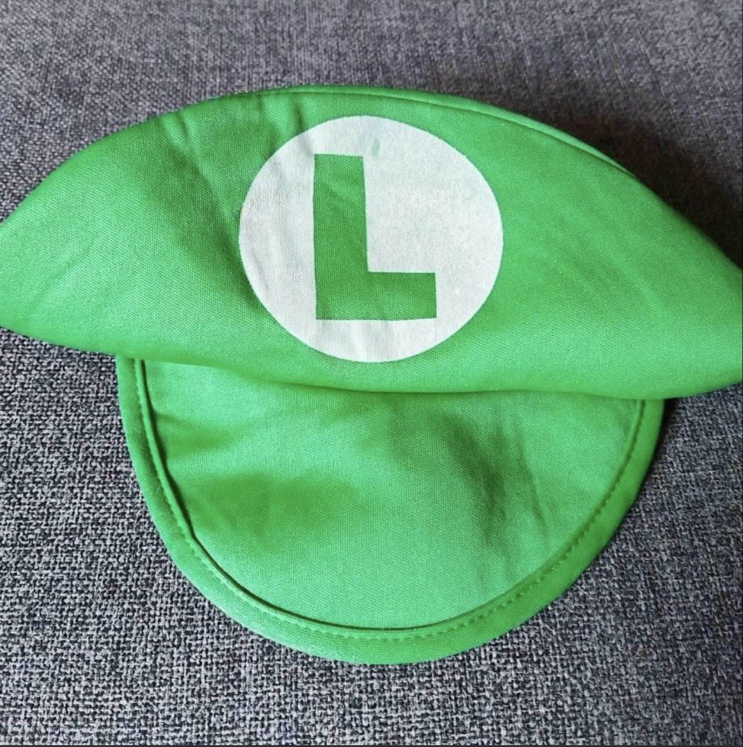 Luigi Costume Jumpsuit and Hat (Category: Babies & Kids Fashion) located in Quezon City. Submitted by ja.layug (Listing ID 1469627730, Image 3). Description: Green and blue Luigi costume set. Includes long-sleeve green top attached to blue overalls with yellow button details. Matching green cap with white circle and green letter L on the front. Neck ties at the back. Fun outfit for dress-up parties or cosplay events. One-piece design makes it qui