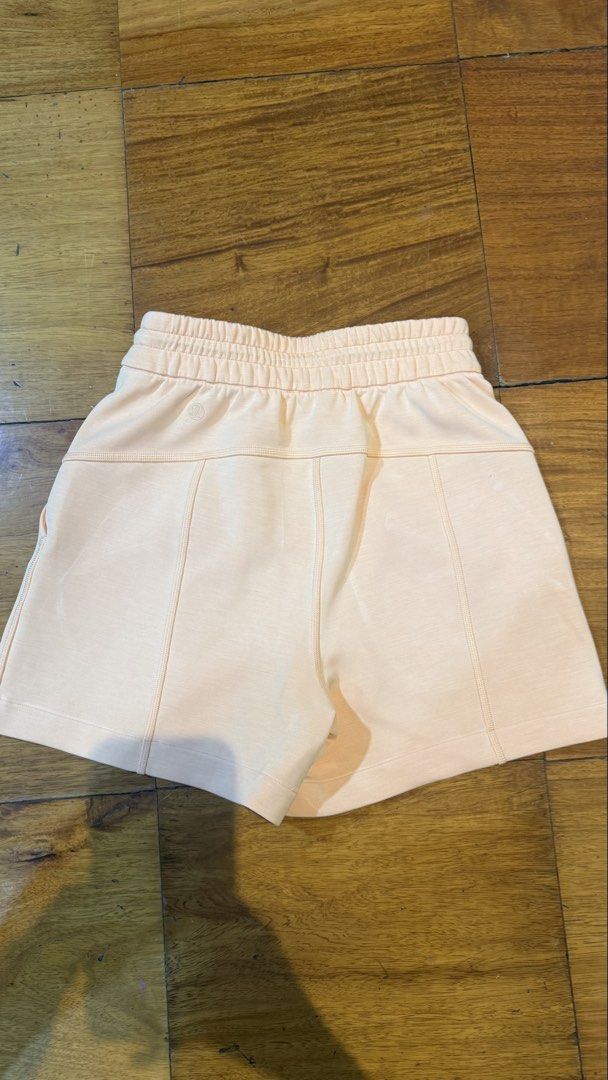 Lululemon High-Rise Shorts 4” (Category: Shorts) located in Makati City. Submitted by thevault88 (Listing ID 1469689906, Image 3). Description: - Brand: Lululemon - Color: Soft Peach - Material: cozy cotton blend fleece - Waistband: Elastic with adjustable cinch cord - Design: Structured paneling on front and back with subtle embroidered logo on back hip.