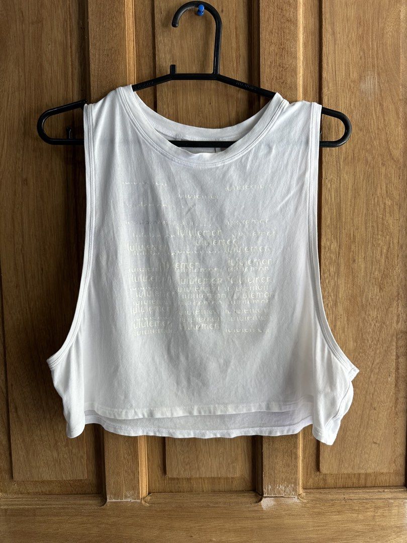 Lululemon White Crop muscle Tank 6 (Category: Activewear) located in Rosales. Submitted by dariang22 (Listing ID 1469601984, Image 2). Description: - Brand: Lululemon - Color: White - Style: Crop tank top with sleeveless design, and dropped armholes - Details: Large tonal front graphic, with curved seams, and reflective back logo stamp - Material: Soft, comfortable cotton - Condition: good as new sana may blue stain pero di halata ibleach mo nlng