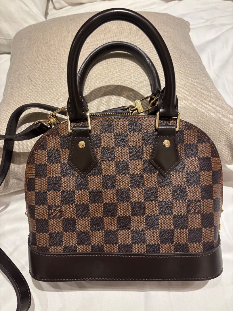 LV Damier Ebene Alma BB Bag (Category: Luxury Bags & Wallets) located in Cebu City. Submitted by bettzy77 (Listing ID 1469750427, Image 2). Description: Only used once or twice. In great condition. With dust bag. No issues or damage at all. - Classic Damier Ebene canvas with dark brown leather trim - Shiny gold-tone hardware and secure top zip closure - Double rolled top handles and detachable shoulder strap for versatile wear - Includes keys in 