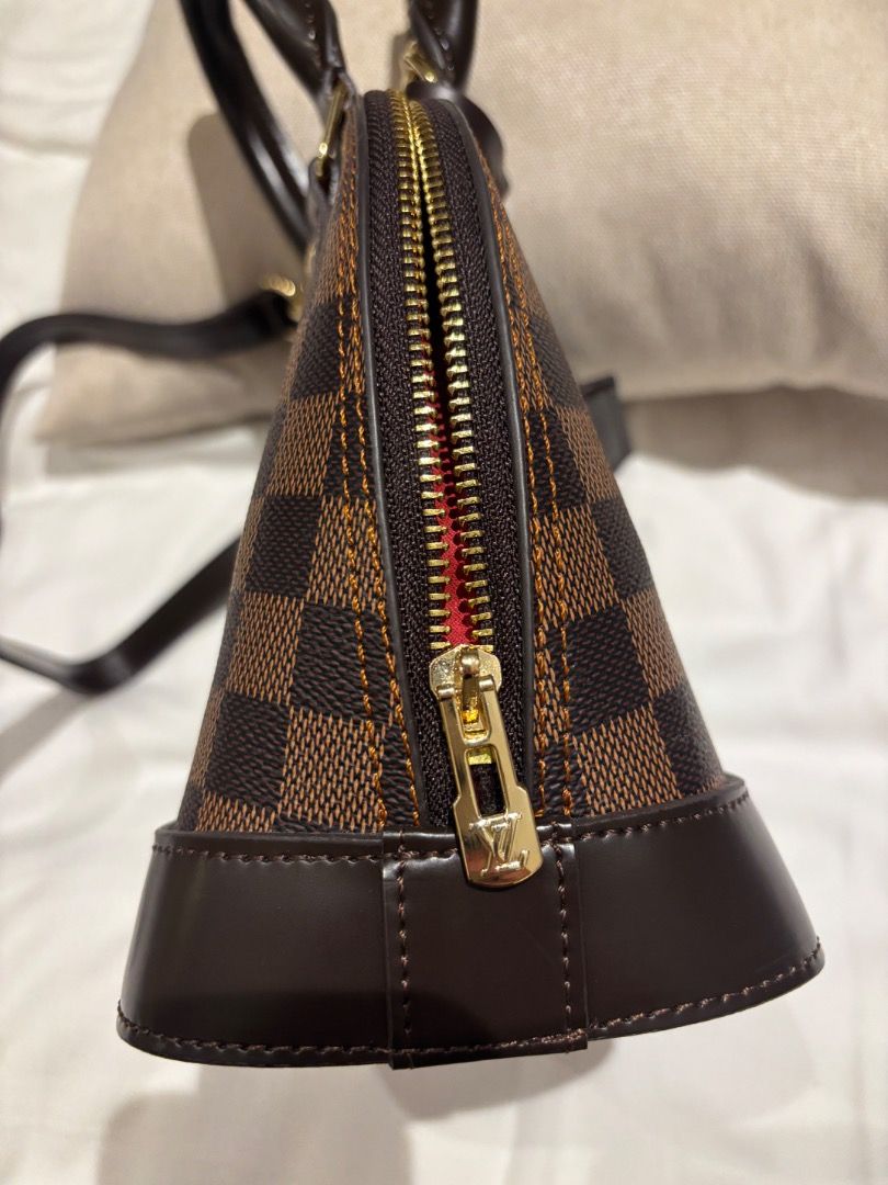 LV Damier Ebene Alma BB Bag (Category: Luxury Bags & Wallets) located in Cebu City. Submitted by bettzy77 (Listing ID 1469750427, Image 3). Description: Only used once or twice. In great condition. With dust bag. No issues or damage at all. - Classic Damier Ebene canvas with dark brown leather trim - Shiny gold-tone hardware and secure top zip closure - Double rolled top handles and detachable shoulder strap for versatile wear - Includes keys in 