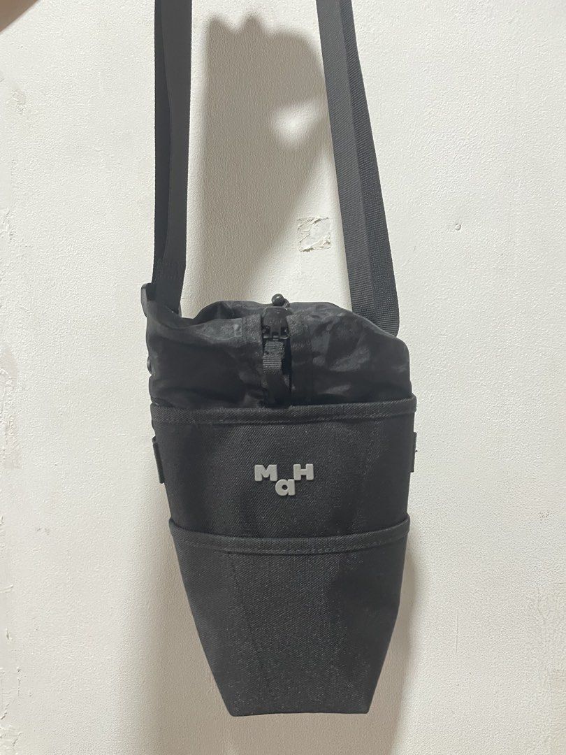 MaH Water Bottle Bag (Category: Cross-body Bags) located in Manila. Submitted by shaquilleoatmeal (Listing ID 1469582174, Image 2). Description: MaH water bottle bag in black. Features a secure drawstring top, adjustable shoulder strap, and minimalist logo design. Perfect for hands-free daily commutes, walks, or hikes. In clean condition..