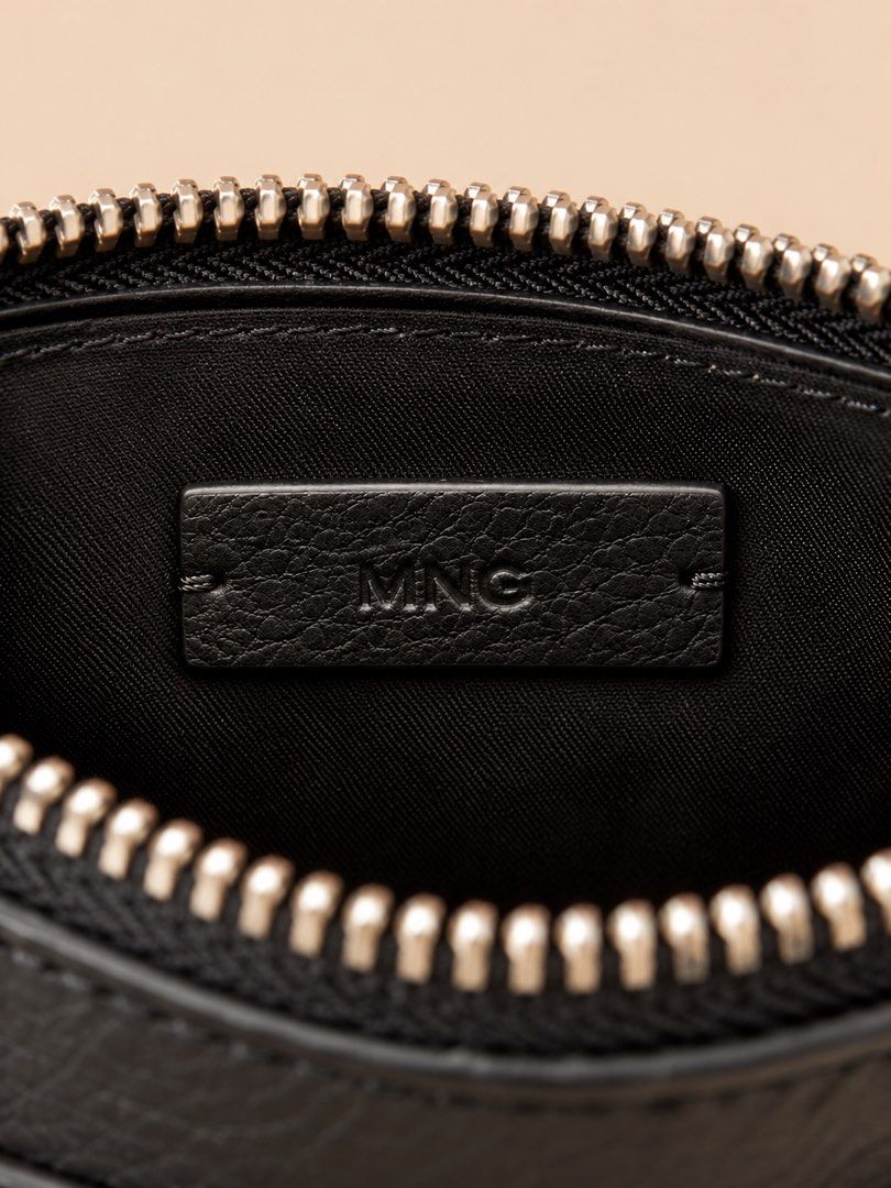 Mango Black Leather Crescent Crossbody Bag (Category: Cross-body Bags) located in Santa Rosa. Submitted by buy888sell (Listing ID 1469611692, Image 3). Description: - Brand: Mango - Material: Bovine leather (genuine) - Hardware: Silver zippers and rings - Features: Front curved slip pocket, fabric lining with branded leather label, top zip closure - Strap: Adjustable with buckle holes - Style: Compact and versatile for everyday use.