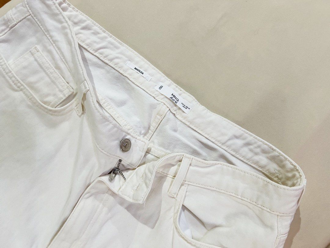 MANGO Denim White Jeans (Category: Jeans) located in Cainta. Submitted by unboxingstuff (Listing ID 1469659584, Image 2). Description: - Brand: MANGO - Brand new - Model: Beige/ Cream Denim Pants - Size: EUR 46 (loose fit and bigger than usual) - Fit: Classic straight / loose fit - Color: Clean white wash - Features: Front and back pockets, silver-toned button, zip fly closure - Condition: Excellent, easy to match with any top - Never used becaus