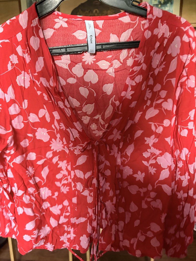 Mango Floral V-Neck Blouse Red Pink (Category: Blouses) located in Quezon City. Submitted by kitsukemen (Listing ID 1469599247, Image 1). Description: - Brand: Mango - Size: EUR M / US 6 - Color/Pattern: Bright red with pink floral & leaf print - Design: Long sleeves, V-neckline with front tie closure - Material: Lightweight & comfortable fabric - Origin: Made in Cambodia - Condition: Excellent pre-loved condition - Mode of Payment: GCash, BPI, o