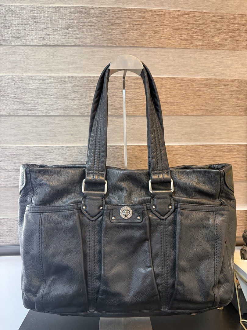 Marc by Marc Jacobs Black Leather Tote Bag (Category: Tote Bags) located in Makati City. Submitted by bagattic_etc (Listing ID 1469620511, Image 2). Description: Brand: Marc by Marc Jacobs Material: Genuine black leather with silver-tone hardware Design: Structured silhouette with multiple exterior pockets and secure turn-lock closure Straps: Comfortable dual shoulder straps Interior: Black and white monogram fabric lining Organization: Features 