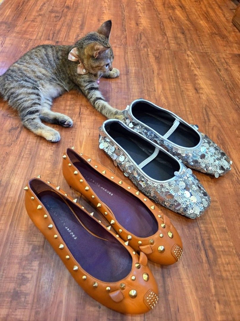 Marc by Marc Jacobs Flats Bundle (Category: Flats & Sandals) located in Manila. Submitted by mysticrabbit.284012 (Listing ID 1469585112, Image 1). Description: - Brand: Marc by Marc Jacobs - Quantity: Set of 2 pairs - Pair 1: Tan leather with gold-tone studs - Pair 2: Shiny silver sequins with comfortable elastic straps - Condition: Both pairs show interior branding - Style: Fun statement shoes, perfect for casual days or nights out.