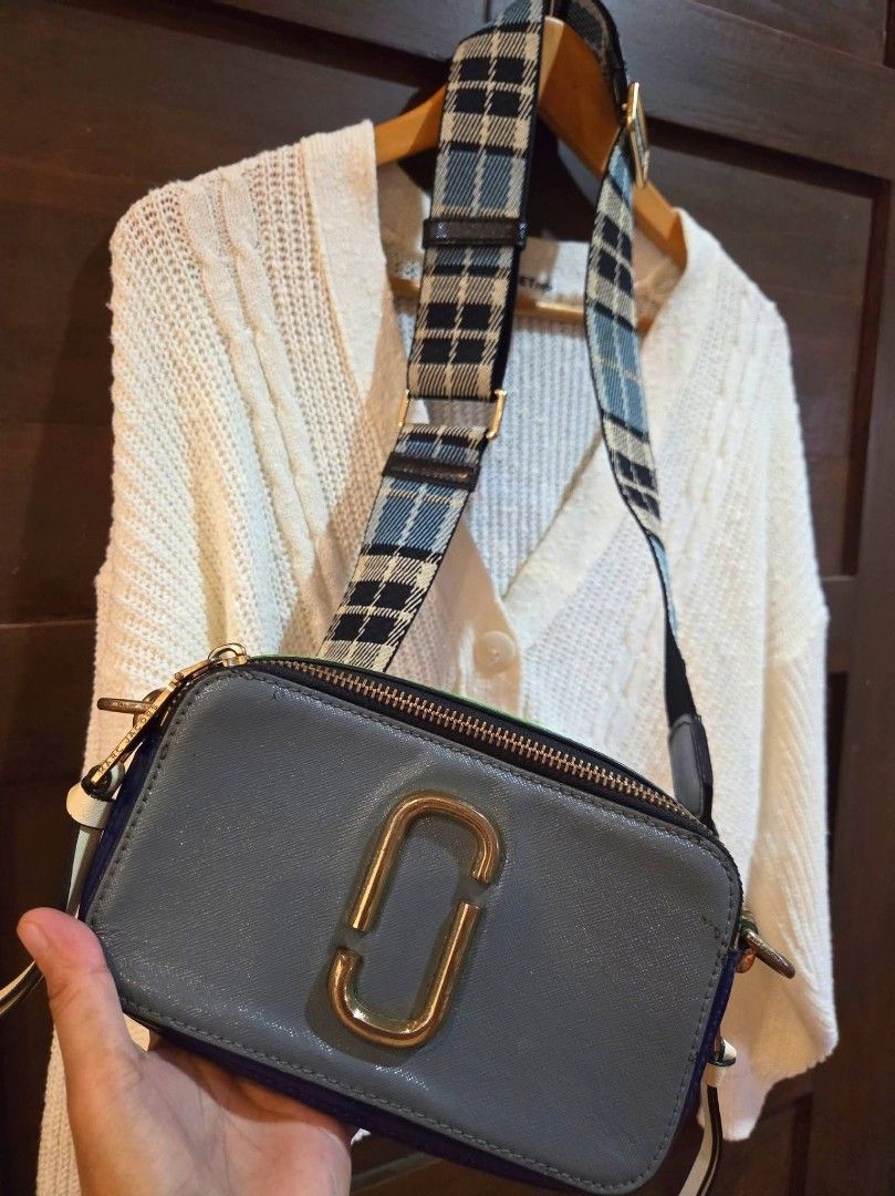 Marc Jacobs Snapshot Camera Bag with Plaid Strap (Category: Luxury Bags & Wallets) located in Manila. Submitted by mysticrabbit.284012 (Listing ID 1469581102, Image 2). Description: - Brand: Marc Jacobs - Style: Multi-color camera bag (Grey, Bright Green, Blue) - Hardware: Gold-tone hardware with leather zipper pull tabs - Compartments: Double zip closure with black fabric interior lining and slip pockets - Strap: Adjustable and thick webbed stra