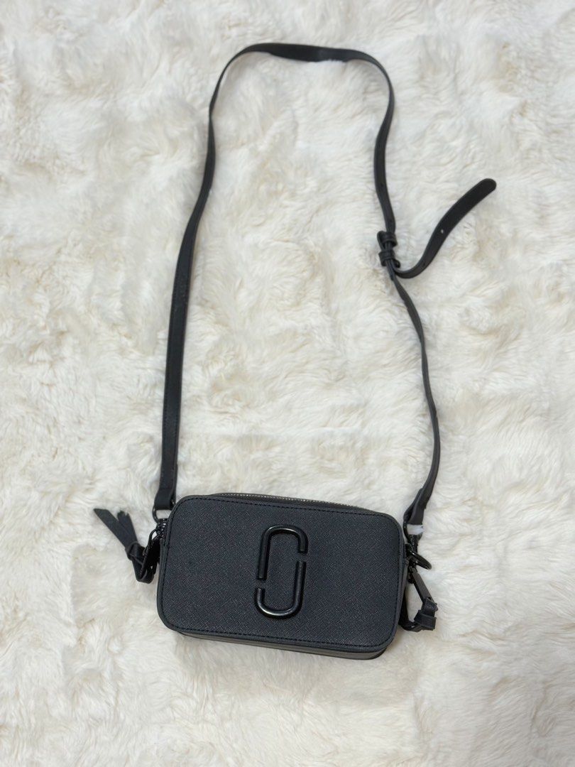 Marc Jacobs Snapshot Crossbody Bag Black (Category: Luxury Bags & Wallets) located in Manila. Submitted by preshyyyyy_ (Listing ID 1469746801, Image 1). Description: - Brand: Marc Jacobs Snapshot Crossbody - Material: Durable black saffiano leather - Hardware: Matte black with signature double J logo - Compartments: Twin zip compartments with fabric lining - Strap: Adjustable and removable thin leather strap - Details: Debossed Marc Jacobs New Yo