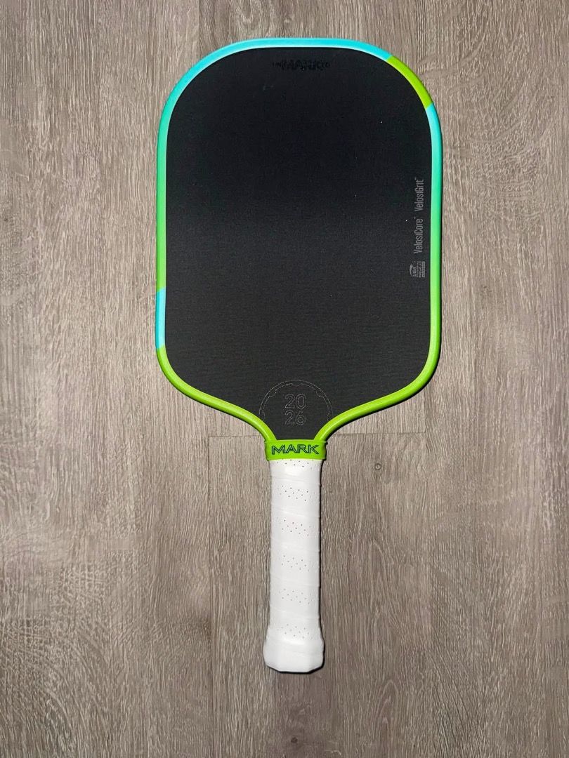 Unmarked 2026 Paddle with White Grip (Category: Racket and Ball Sports) located in Balagtas. Submitted by pitsgarments (Listing ID 1469749412, Image 1). Description: - Stylish black surface with eye-catching green and turquoise edge trim - Lightweight design with a textured face for maximum spin control - Comfortable white wrapped handle featuring perforation details for better grip - Standard shape with rounded corners for versatile play - Featu