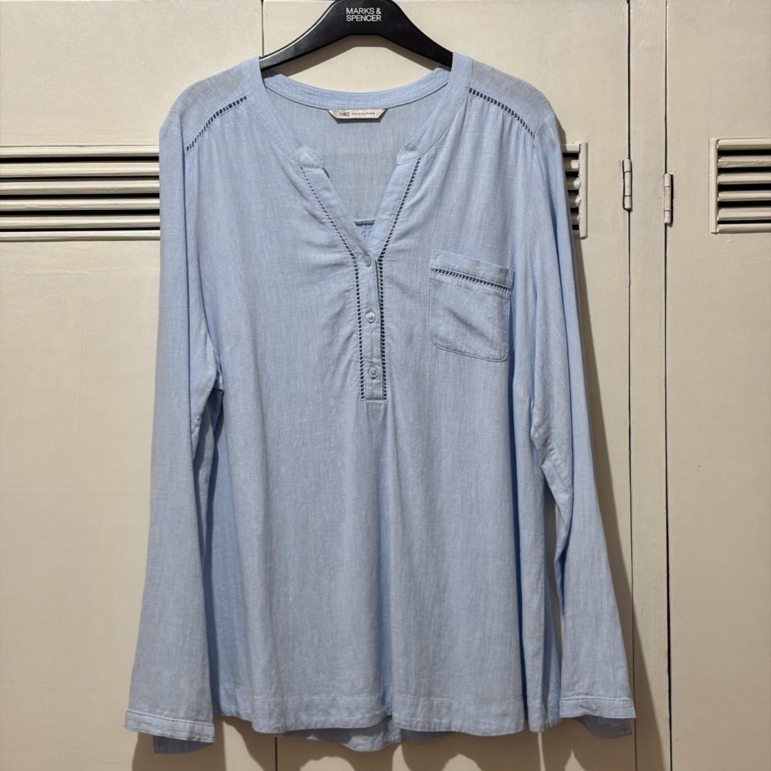 Marks & Spencer Linen Blend Chambray Top UK 16 (Category: Blouses) located in Quezon City. Submitted by tflquezoncity (Listing ID 1469737766, Image 1). Description: ❤️ Marks & Spencer ❤️ UK 16 ❤️ Linen-viscose blend ❤️ Light blue chambray ❤️ Button-down neckline, chest pocket, delicate eyelet trim ❤️ Great condition, no issues ❤️ Easy to pair with leggings or shorts for casual everyday wear.