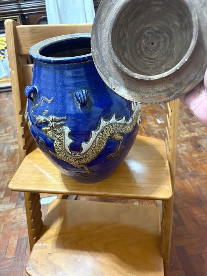 martaban Blue glazed ceramic storage jar with dragon relief (Category: Vases & Decorative Bowls) located in Alfonso. Submitted by luckyfire_80773d (Listing ID 1469593706, Image 2). Description: - Deep blue glazed ceramic jar with matching lid - Intricately sculpted dragon wrapped around the body with detailed scales and claws - Accentuated with earthy tones and small decorative loop handles - Authentic unglazed coarse clay base showing natural we