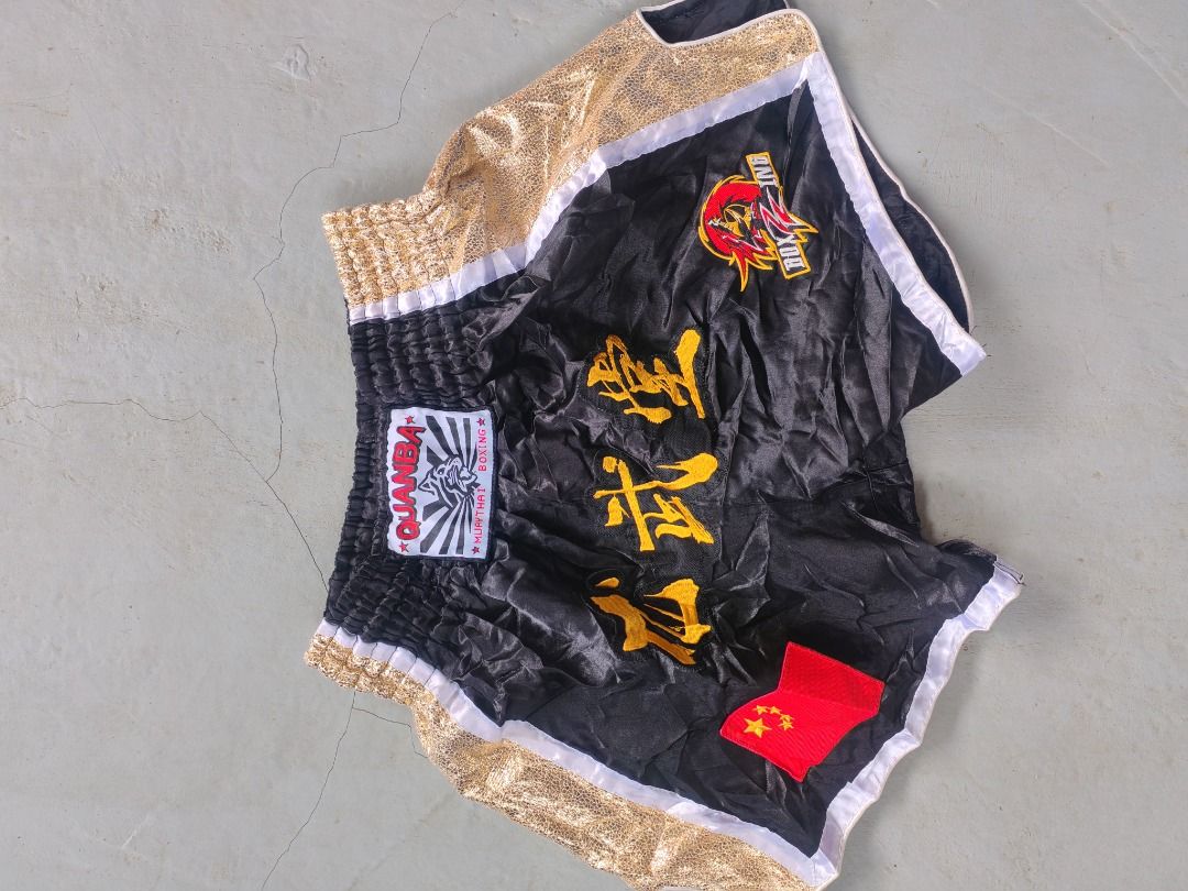 Martial arts fighting shorts bundle red and black (Category: Shorts) located in Caloocan City. Submitted by silverbird_6c038f (Listing ID 1469601091, Image 3). Description: - Set of 2 martial arts shorts for training and sparring - Pair 1: Red with white flame graphics and Chinese lettering embroidery - Pair 2: Black and gold with Chinese characters and a Chinese flag patch - Comfortable elastic waistband on both pairs - Great for gym workouts, m