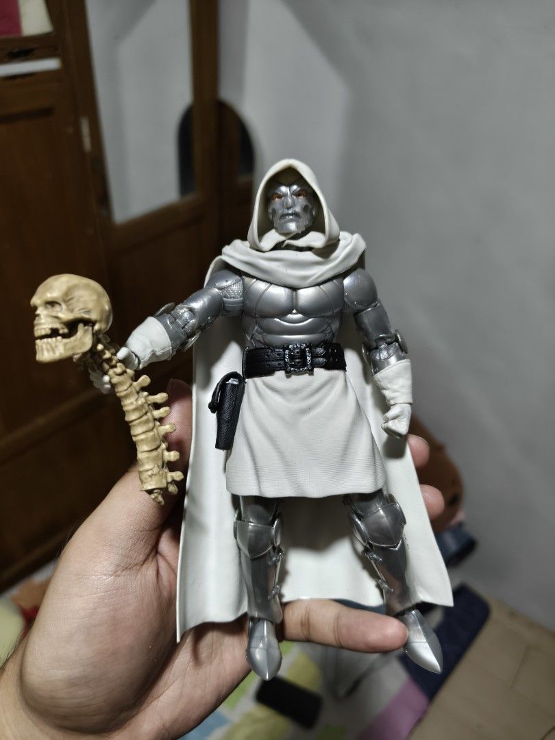 Marvel Legends God Doom Action Figure with Spine Accessory (Category: Figurines & Statues) located in Rizal. Submitted by kencamara (Listing ID 1469610425, Image 1). Description: FOR TRADE FOR TRADE FOR TRADE to any MCU fig - Character: God Doom Action Figure - Appearance: Clean white and silver armor with a detachable white cape - Accessories: Black belt with pouch and spine with skull accessory - Articulation: Highly articulated joints at shoul
