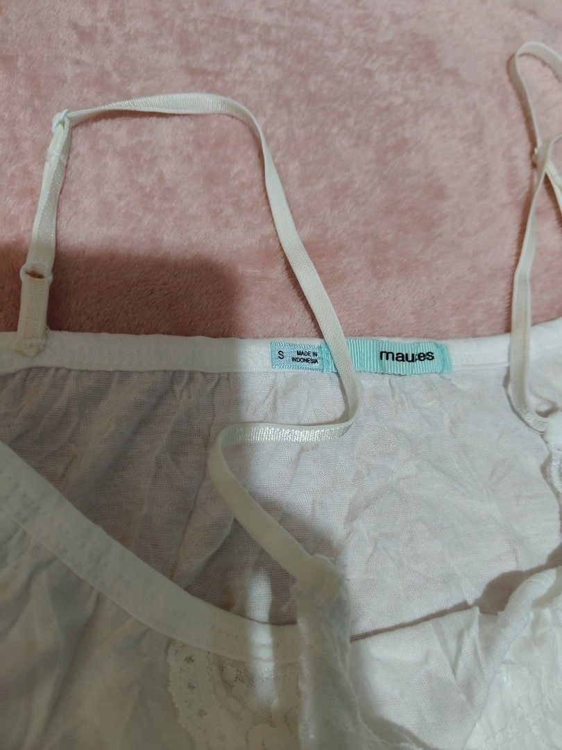 Maurices White Lace Cami Top Size S (Category: Sleeveless) located in Villasis. Submitted by trip_thrift15 (Listing ID 1469698983, Image 3). Description: - Brand: Maues - Size: S (Made in Indonesia) - Color: White - Details: Adjustable spaghetti straps, pretty lace trim on neckline and bottom hem - Material: Light, comfortable fabric - Length: Approx. 27 inches - Condition: Great basic piece for layering or sleepwear flaws-Tinged with color on ba