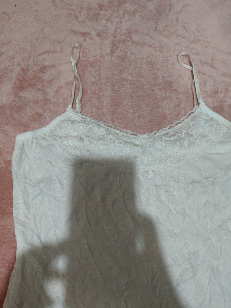 Maurices White Lace Cami Top Size S (Category: Sleeveless) located in Villasis. Submitted by trip_thrift15 (Listing ID 1469698983, Image 2). Description: - Brand: Maues - Size: S (Made in Indonesia) - Color: White - Details: Adjustable spaghetti straps, pretty lace trim on neckline and bottom hem - Material: Light, comfortable fabric - Length: Approx. 27 inches - Condition: Great basic piece for layering or sleepwear flaws-Tinged with color on ba