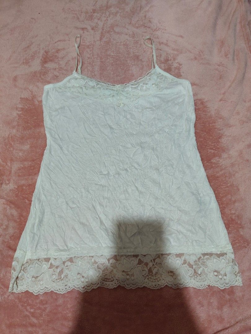 Maurices White Lace Cami Top Size S (Category: Sleeveless) located in Villasis. Submitted by trip_thrift15 (Listing ID 1469698983, Image 1). Description: - Brand: Maues - Size: S (Made in Indonesia) - Color: White - Details: Adjustable spaghetti straps, pretty lace trim on neckline and bottom hem - Material: Light, comfortable fabric - Length: Approx. 27 inches - Condition: Great basic piece for layering or sleepwear flaws-Tinged with color on ba