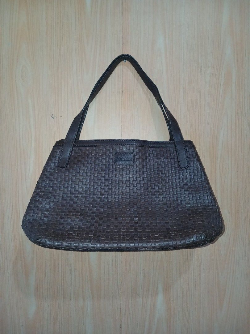 Max Mara woven leather shoulder bag brown (Category: Luxury Bags & Wallets) located in Daraga. Submitted by thethriftcity2024 (Listing ID 1469607339, Image 1). Description: - Brand: Max Mara - Material: Genuine woven leather in dark brown (intrecciato pattern) - Closure: Magnetic snap top - Interior: Dark fabric lining with zipper pocket and branded leather patch - Straps: Dual shoulder straps - Condition: Minor scuffing on the woven edges at the