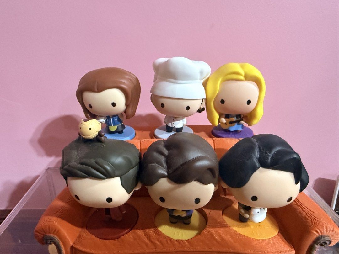 MCDO FRIENDS TV Show Figures with orange couch display stand (Category: Designer & Blind Box Toys) located in Tarlac. Submitted by starmie_quail (Listing ID 1469696140, Image 2). Description: - Complete set of all 6 main characters from Friends - Includes Monica (chef hat), Phoebe (guitar), Rachel, Ross (with monkey), Chandler (with duck), and Joey (with chick) - Arranged on the iconic orange Central Perk couch with show logo - Perfect display pi