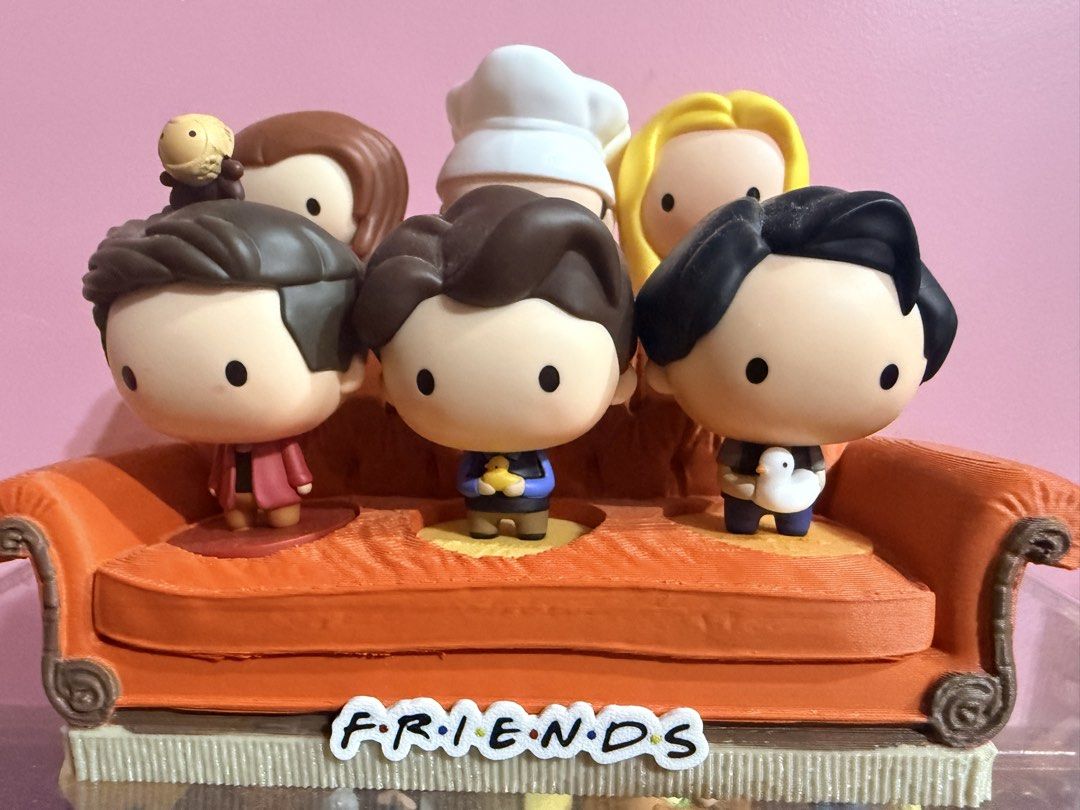 MCDO FRIENDS TV Show Figures with orange couch display stand (Category: Designer & Blind Box Toys) located in Tarlac. Submitted by starmie_quail (Listing ID 1469696140, Image 3). Description: - Complete set of all 6 main characters from Friends - Includes Monica (chef hat), Phoebe (guitar), Rachel, Ross (with monkey), Chandler (with duck), and Joey (with chick) - Arranged on the iconic orange Central Perk couch with show logo - Perfect display pi