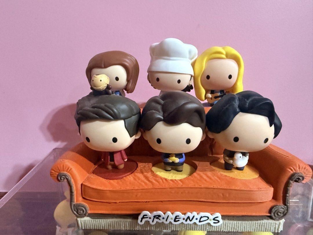 MCDO FRIENDS TV Show Figures with orange couch display stand (Category: Designer & Blind Box Toys) located in Tarlac. Submitted by starmie_quail (Listing ID 1469696140, Image 1). Description: - Complete set of all 6 main characters from Friends - Includes Monica (chef hat), Phoebe (guitar), Rachel, Ross (with monkey), Chandler (with duck), and Joey (with chick) - Arranged on the iconic orange Central Perk couch with show logo - Perfect display pi