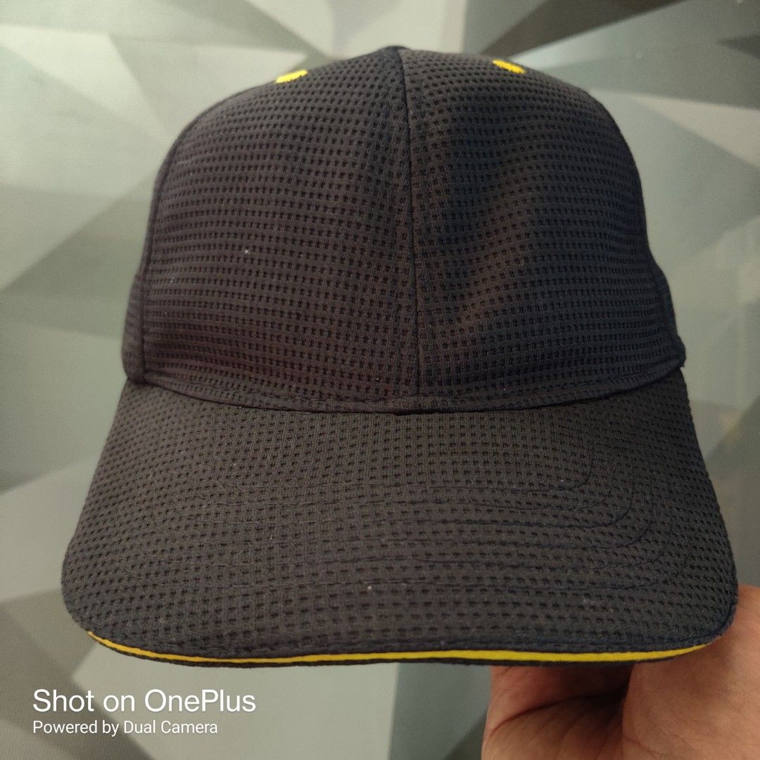 McDonald's crew member uniform snapback hat (Category: Caps & Hats) located in Baguio. Submitted by ferns_garage.0924 (Listing ID 1469634204, Image 1). Description: This is an official McDonald's crew member uniform snapback hat from the brand's apparel collection. Material: Midnight navy blue waffle-textured mesh/polyester fabric. Details: Features the iconic yellow eyelets on top and a distinctive red rectangular tag with a yellow "M" logo on t