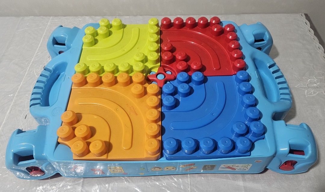 MegaBloks Kids Activity Table with Building Blocks and Storage (Category: Lego & Building Sets) located in Quezon City. Submitted by newgem.b5485b (Listing ID 1469587181, Image 2). Description: - Multi-color activity table featuring green, red, blue, and orange top plates - Flip panels to easily store building blocks inside the table body - Built-in side handles for convenient carrying - Foldable red legs make storage quick and simple - Fun decor