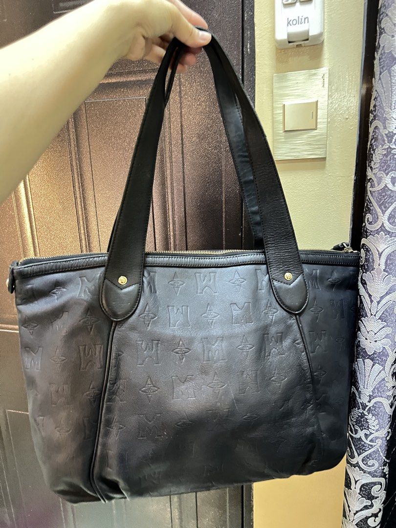 Metrocity Black Leather Monogram Tote Bag (Category: Tote Bags) located in Manila. Submitted by colineb (Listing ID 1469669088, Image 3). Description: - Brand: Metrocity - Material: Premium black leather with debossed monogram pattern - Hardware: Elegant gold-tone hardware and front logo emblem - Closure: Secure zip-top closure - Straps: Comfortable double shoulder straps with stud details - Interior: Fabric-lined with a convenient zippered pocke