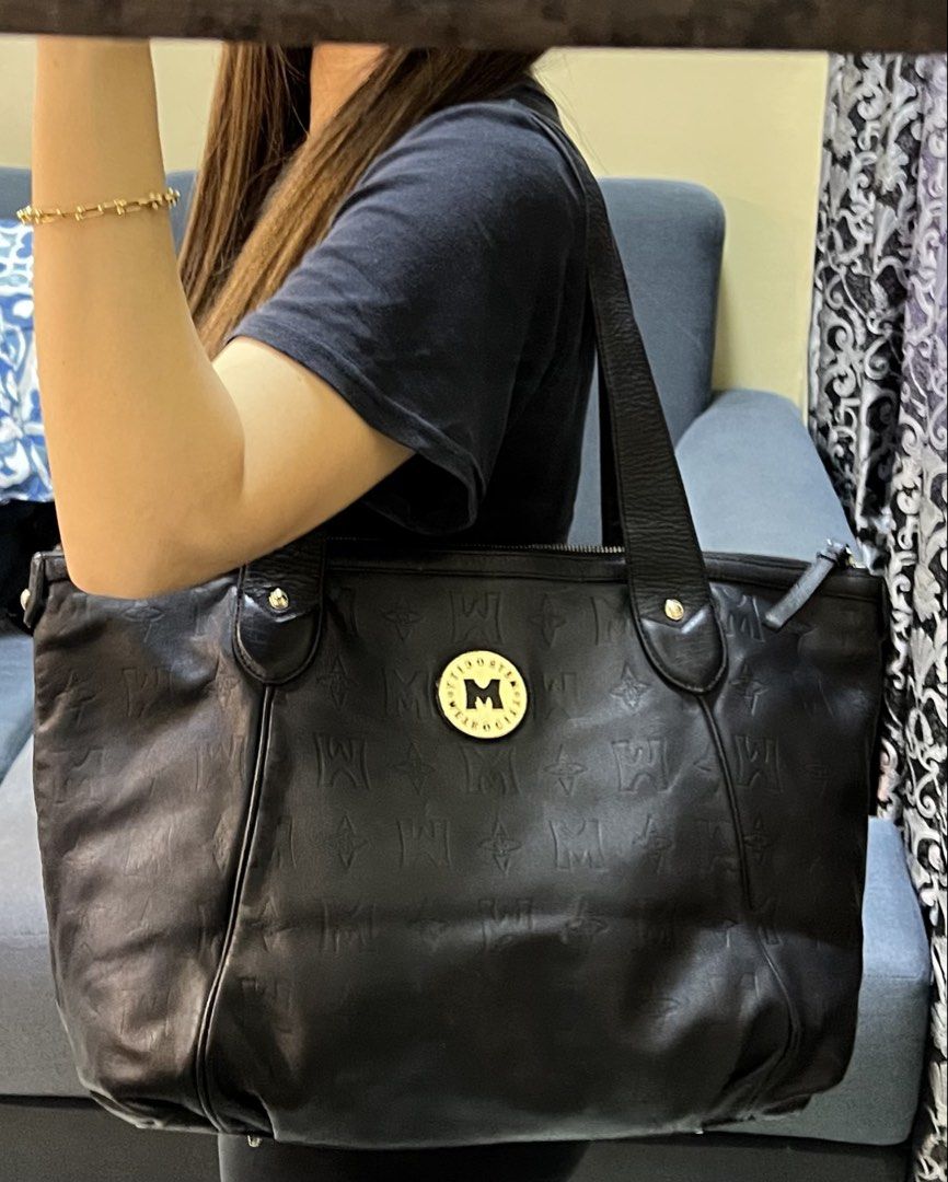 Metrocity Black Leather Monogram Tote Bag (Category: Tote Bags) located in Manila. Submitted by colineb (Listing ID 1469669088, Image 1). Description: - Brand: Metrocity - Material: Premium black leather with debossed monogram pattern - Hardware: Elegant gold-tone hardware and front logo emblem - Closure: Secure zip-top closure - Straps: Comfortable double shoulder straps with stud details - Interior: Fabric-lined with a convenient zippered pocke