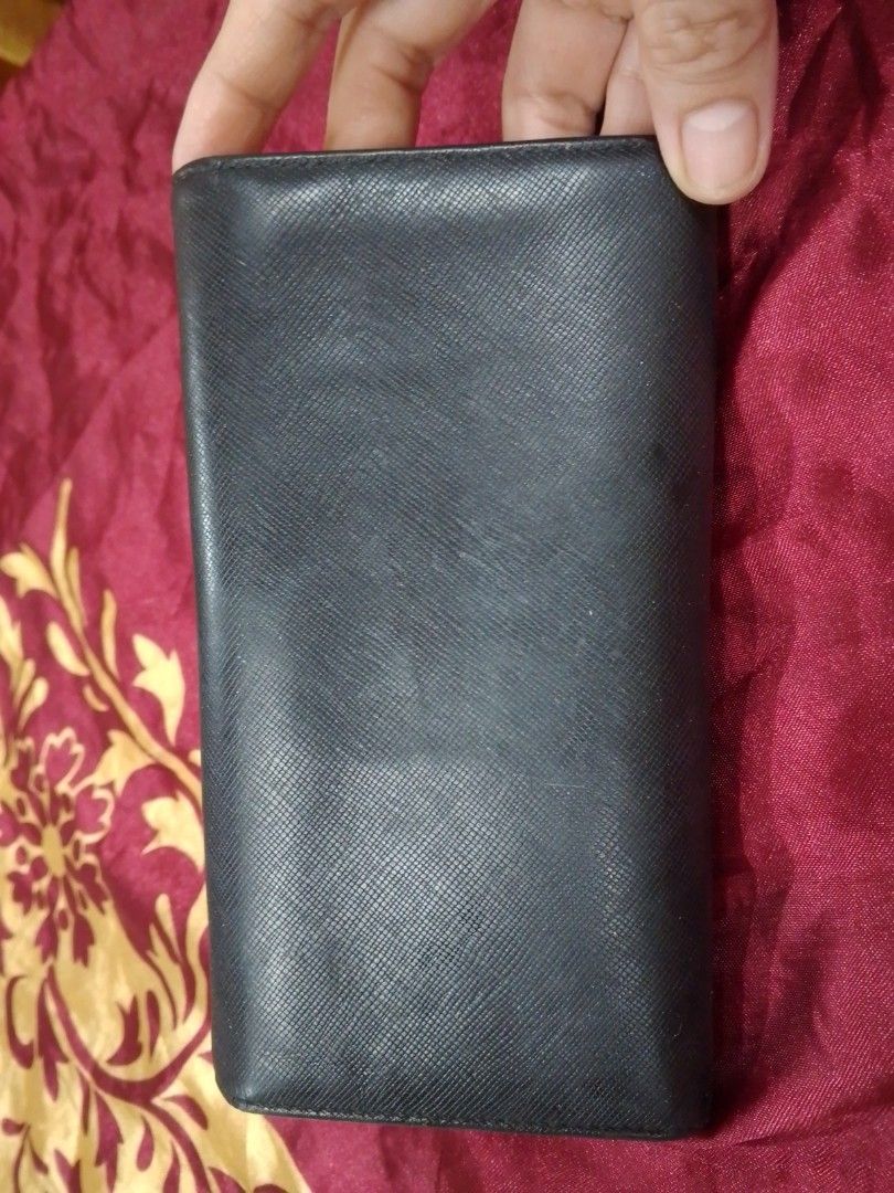 Metrocity Multicolored Long Wallet (Category: Wallets & Card holders) located in Manila. Submitted by annemil_1984 (Listing ID 1469586767, Image 3). Description: Metrocity long wallet in black exterior with vibrant interior compartments in pink, yellow, and orange. Multiple card slots, clear ID window, and snap closure. Metal hardware details on the flap and corners. Interior shows some minor marks on the yellow cardholder section from previous u