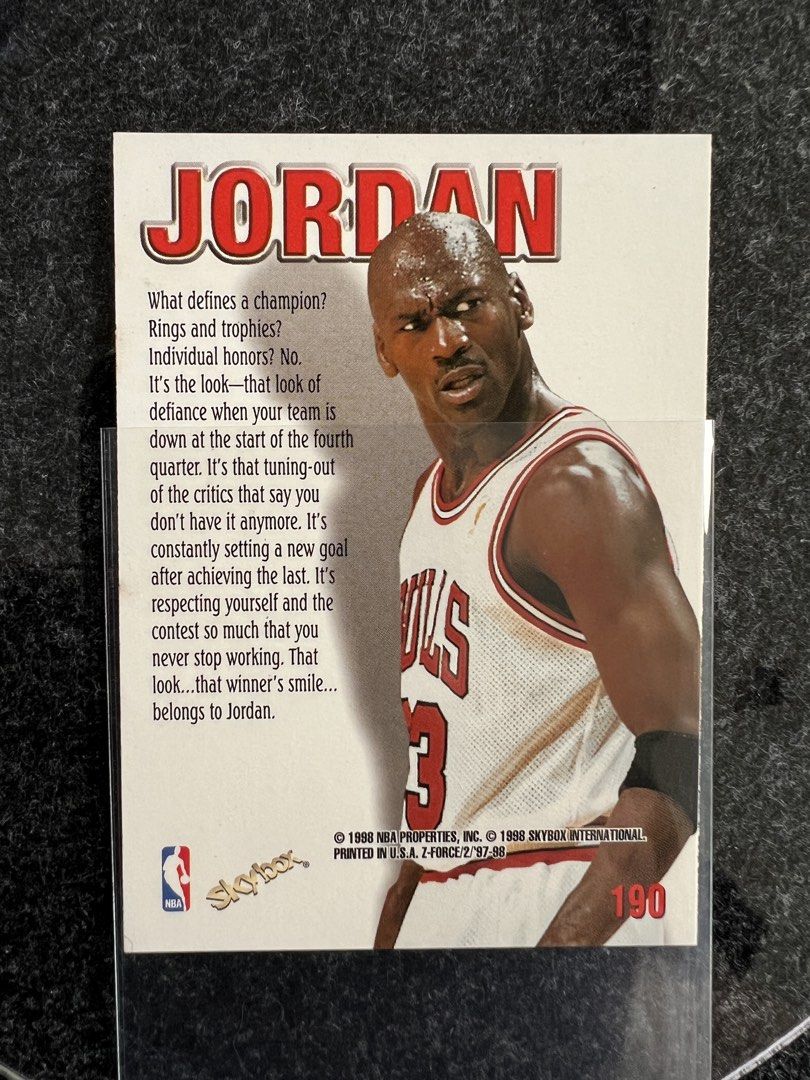 Michael Jordan TCG_FEATURES_OTHERS (Category: Raw Singles) located in Mandaluyong City. Submitted by maropa (Listing ID 1469589156, Image 2). Description: - Item: 1997-98 Michael Jordan Z-Force Trading Card - Card Number: #190 (Z-Supermen Subset) - Design: Stunning gold background with embossed silver lettering and Bulls #23 layout - Reverse: Includes player quote and 1998 SkyBox copyright - Condition/Protection: Well-preserved and kept inside a 