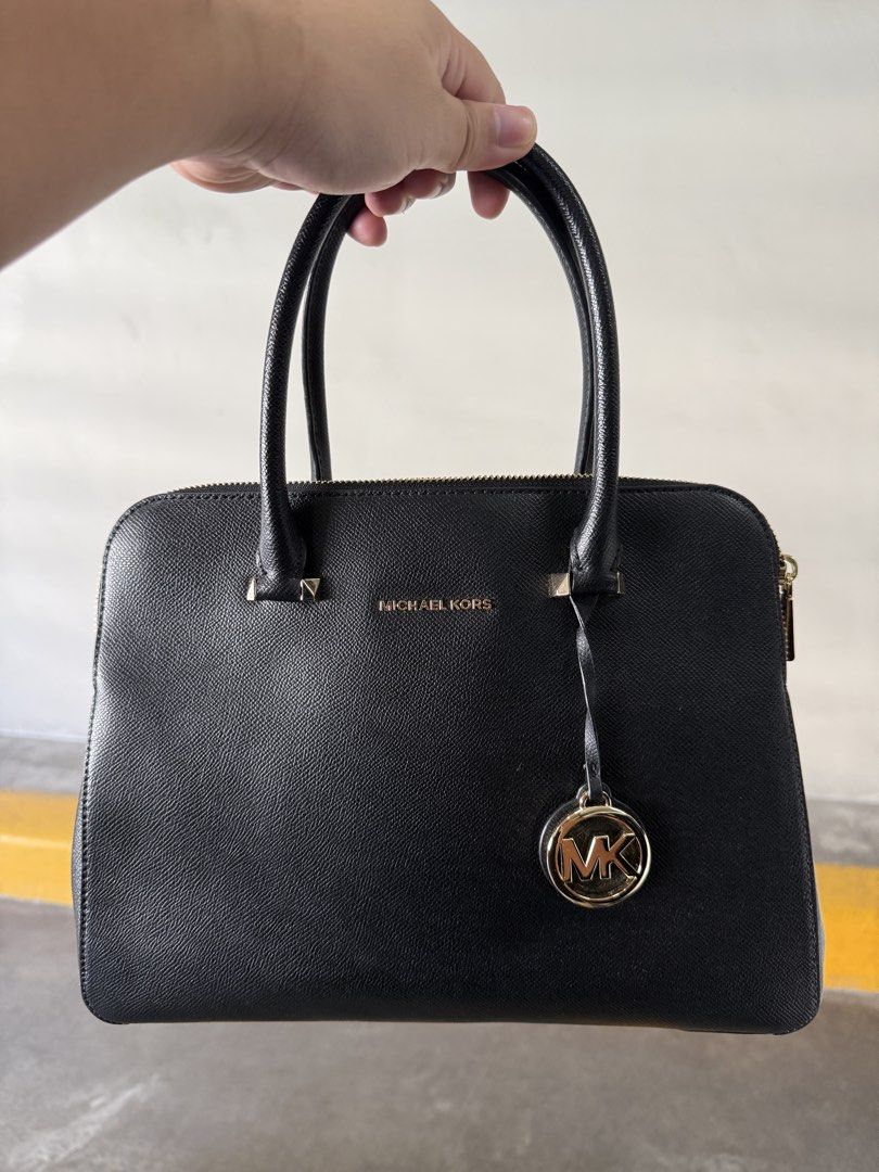 Michael Kors Black Leather Satchel Handbag (Category: Luxury Bags & Wallets) located in Muntinlupa City. Submitted by golf823 (Listing ID 1469591255, Image 1). Description: - Brand: Michael Kors - Material: Genuine Black Leather - Hardware: Gold-tone - Design: Structured satchel with dual top handles and iconic MK logo charm - Compartments: Double zipped top compartments with clean black fabric lining and multiple sections - Very good condition, 