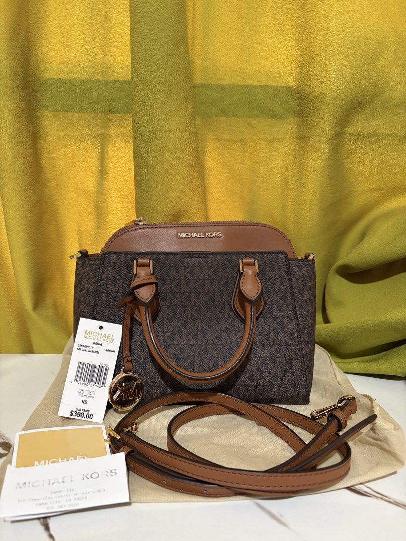 Michael Kors Daria Satchel (small) (Category: Luxury Bags & Wallets) located in Borongan. Submitted by charmspreloveddd (Listing ID 1469637776, Image 1). Description: - 100% Authentic Michael Kors Daria Small 2-in-1 Satchel - Color: Brown monogram print with tan leather details and gold-tone hardware - Versatile carry: Double top handles + adjustable, detachable shoulder strap - Interior: Secure top zip closure, logo fabric lining, and handy slip