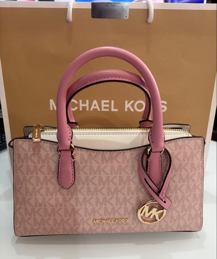 Michael Kors Pink MK Monogram Satchel Bag (Category: Luxury Bags & Wallets) located in Makati City. Submitted by shukufukucy (Listing ID 1469720493, Image 1). Description: Michael Kors Mini Bag * MK Pink Mini Bag with Strap * 8.75”W X 5.25”H X 3”D * Brand New from MK Japan * with Dust Bag ＆Paper Bag * Selling Price: Php 21,000.00 Note: Mode of Payment: * Gcash * Maya * Bank Transfer **Payment first before Pick Up by Lalamove or Grab arranged by c