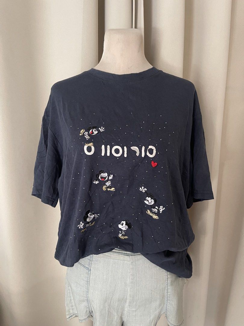 Mickey Embroidered Dark Blue (Category: Shirts) located in Cainta. Submitted by zlove111 (Listing ID 1469620101, Image 2). Description: - Color: Dark blue cotton xl 22" - Design: All-over embroidered Mickey Mouse graphics with white text and silver rhinestone studs - Detail: Small red heart patch near the center - Fit: Relaxed fit with short sleeves - Style: Great casual piece for Disney fans.
