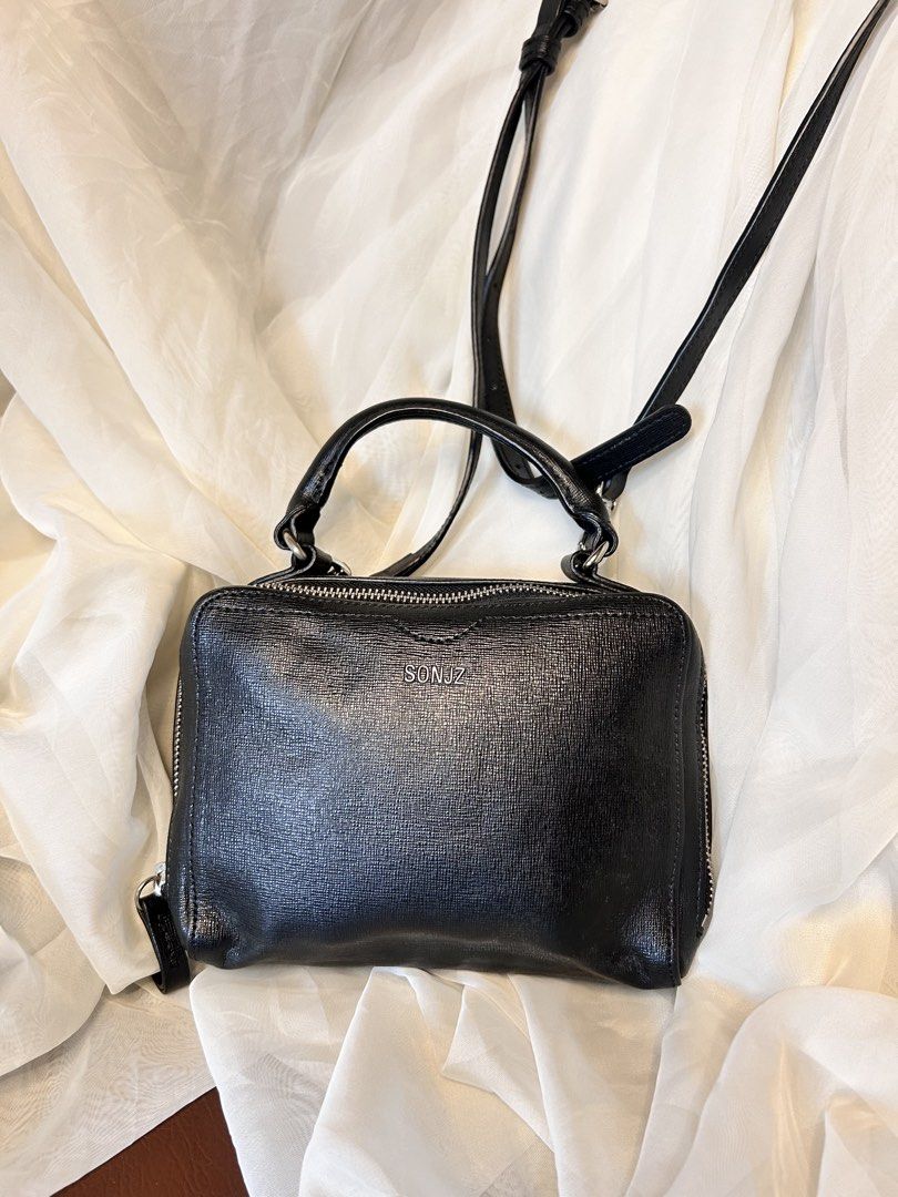 MINI STRUCTURED TOP-HANDLE CROSSBODY / BOX BAG (Category: Cross-body Bags) located in Baguio. Submitted by chmlnstudios (Listing ID 1469685001, Image 2). Description: MINI STRUCTURED TOP-HANDLE CROSSBODY / BOX BAG CODE: C11-B06 A versatile, structured mini box bag in classic black textured leather featuring a vibrant contrast orange interior lining. Designed with a sturdy top grab handle and a long adjustable crossbody sling strap, making it an e