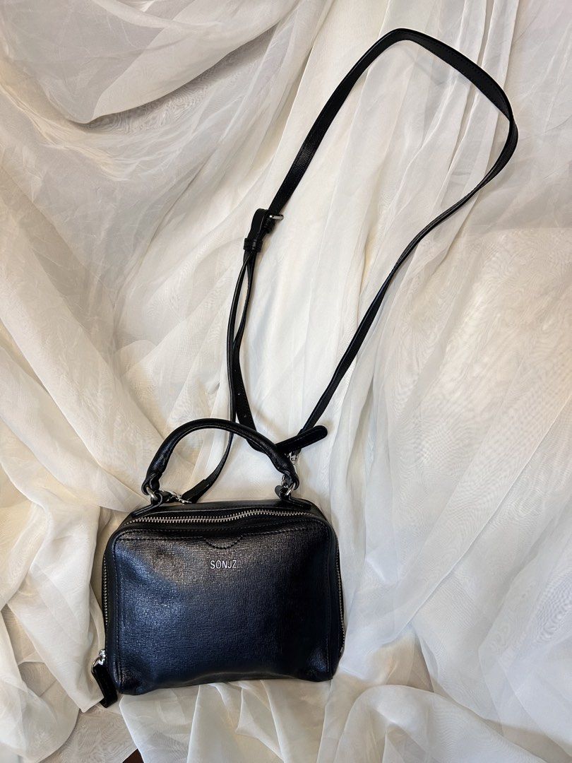 MINI STRUCTURED TOP-HANDLE CROSSBODY / BOX BAG (Category: Cross-body Bags) located in Baguio. Submitted by chmlnstudios (Listing ID 1469685001, Image 1). Description: MINI STRUCTURED TOP-HANDLE CROSSBODY / BOX BAG CODE: C11-B06 A versatile, structured mini box bag in classic black textured leather featuring a vibrant contrast orange interior lining. Designed with a sturdy top grab handle and a long adjustable crossbody sling strap, making it an e
