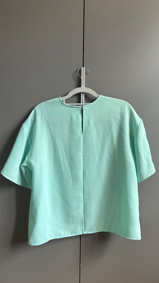 Mint Green Short Sleeve Boxy Blouse Top (Category: Blouses) located in Cavite. Submitted by bravesoul99 (Listing ID 1469730462, Image 2). Description: - Color: Mint Green Fit up to large Uniqlo inspired top , georgette fabric - Fit: Boxy cut, relaxed short sleeves - Details: Round neckline with small back button closure - Fabric: Soft and lightweight - Style: Plain design, easy to match with pants or skirts for daily wear.