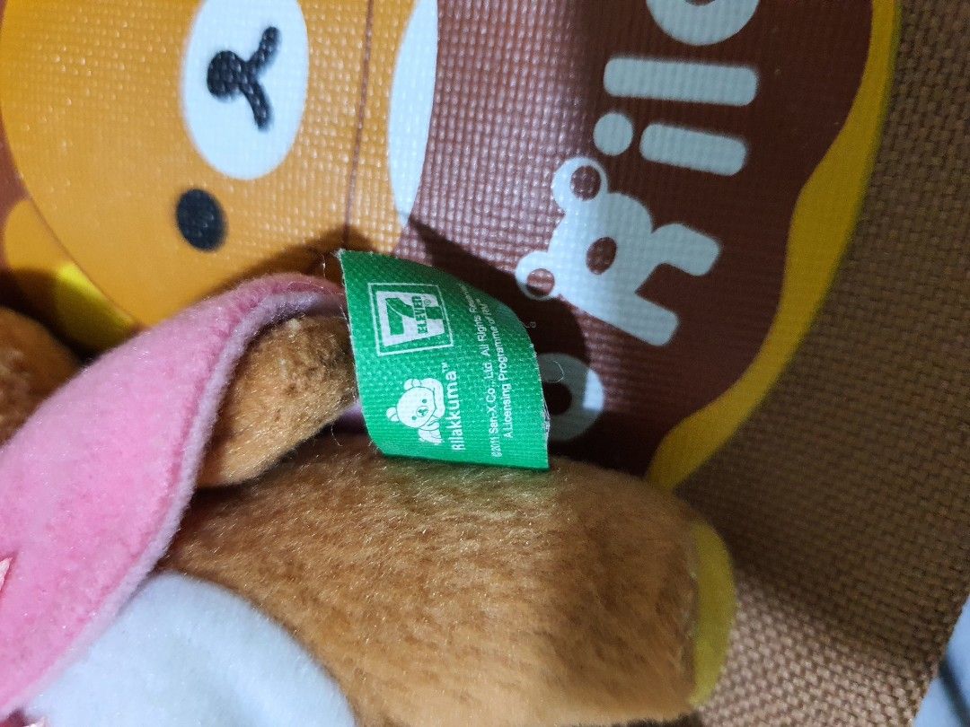 Misdo Rilakkuma 7-Eleven Tote Bag with Plush (Category: Plushies & Soft Toys) located in Quezon City. Submitted by peachhalves (Listing ID 1469583533, Image 2). Description: BUNDLE] Authentic San-X Rilakkuma x Mister Donut Tote Bag & Pink Cape Plush Charm • Japan Surplus / Preloved (Please refer to the photo for the actual condition of the items). • Colors are still vibrant, and the plush material is soft and intact Bag Interior (Flaw): The inner